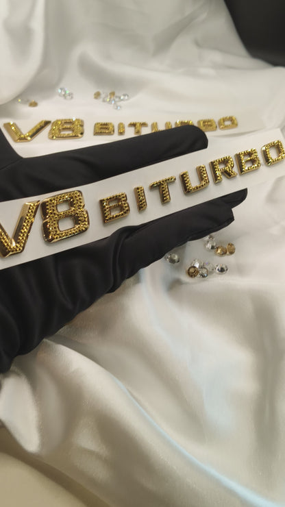Original OEM | Mercedes-Benz AMG V8 Biturbo Gold 24k Logo Emblem Set 2 Stück | mit original Preciosa® Kristallen